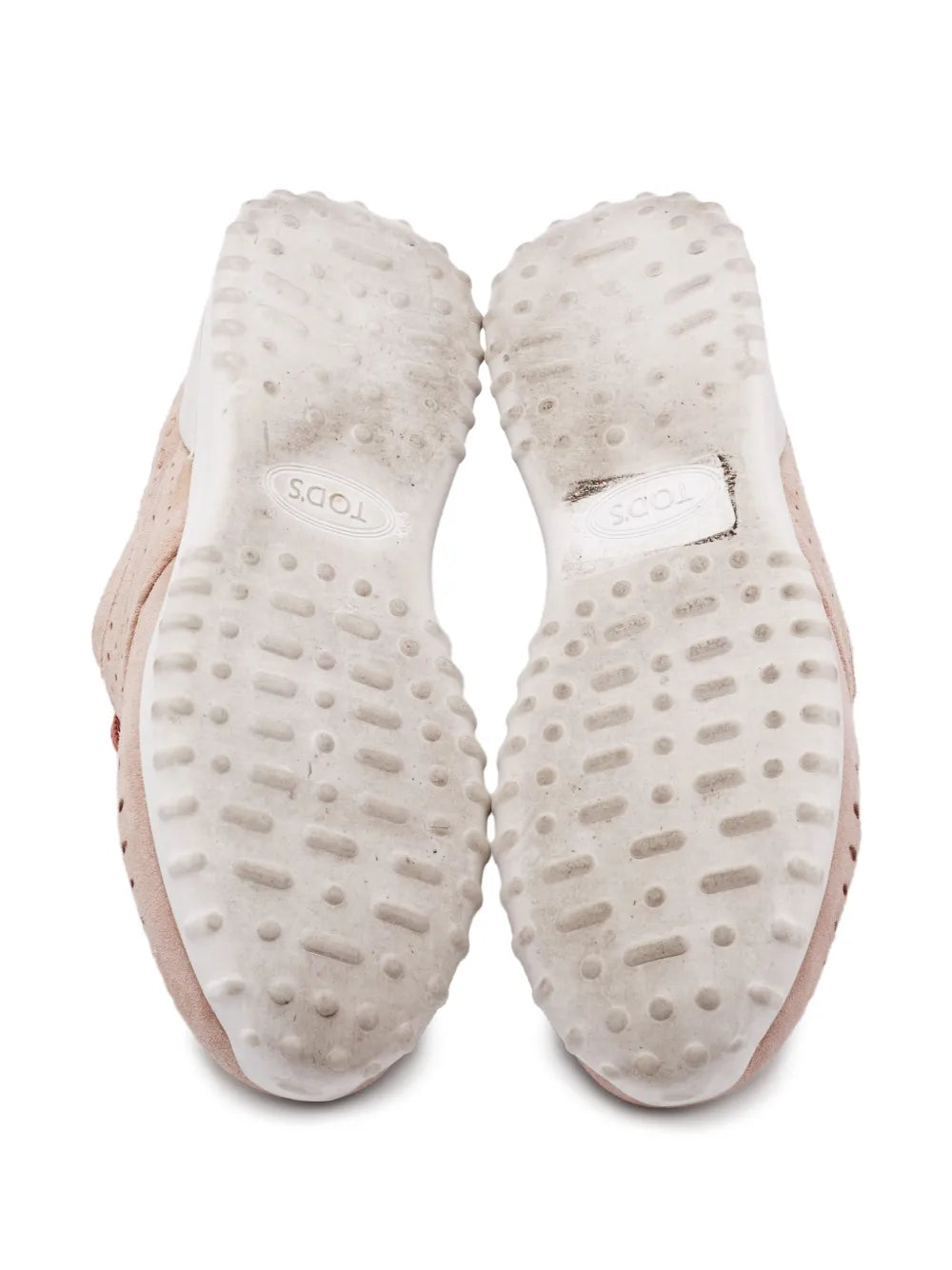 Inner sides of dusty pink suede sneaker uppers with textured traction pattern