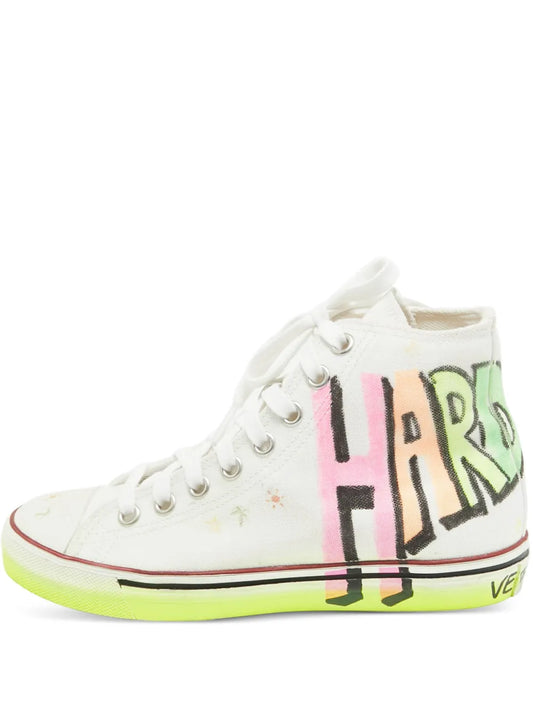 White high-top sneakers with colorful graffiti print and neon green sole