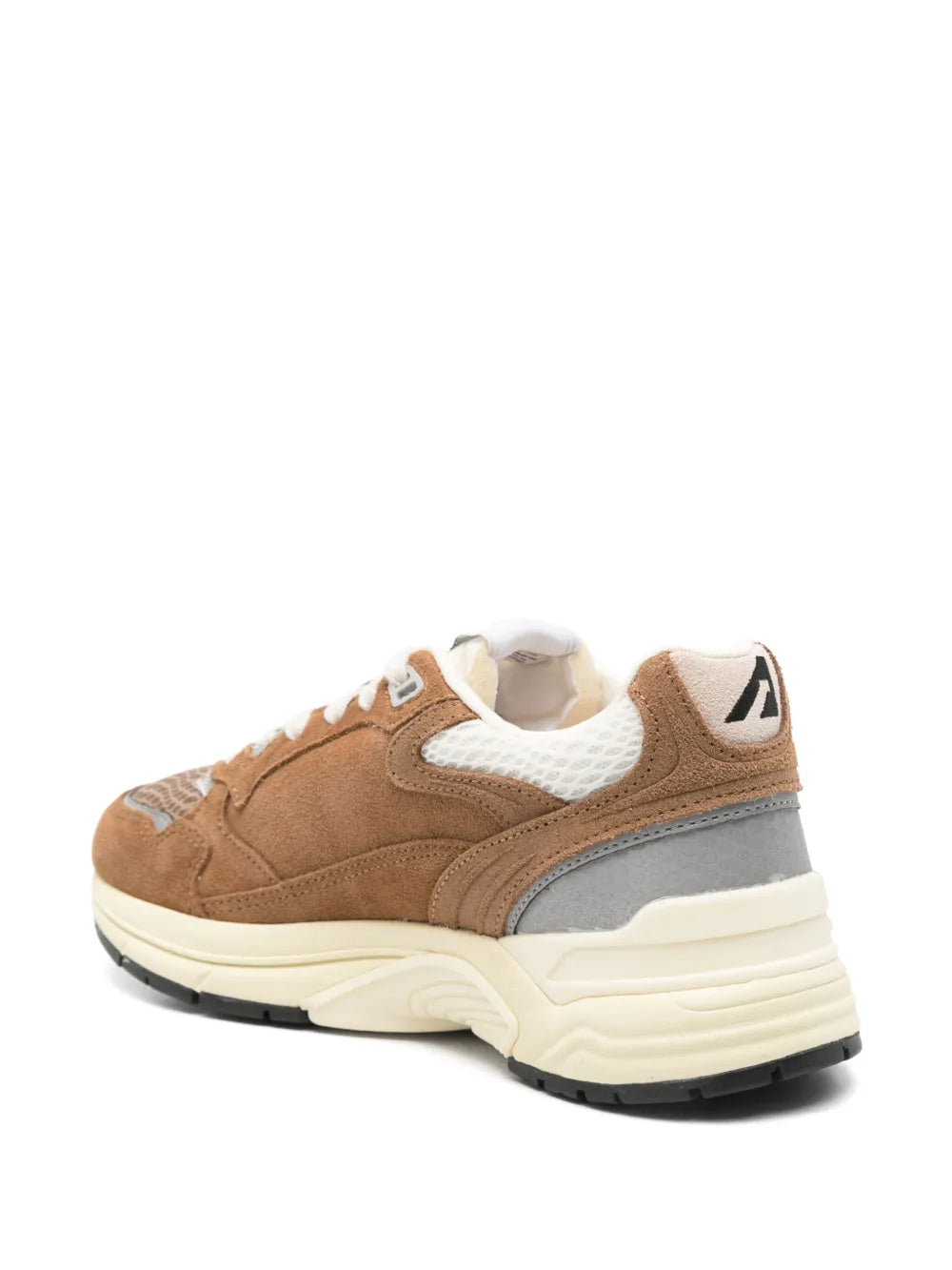 Brown and gray low-top sneakers with white laces, side panels, and black tread