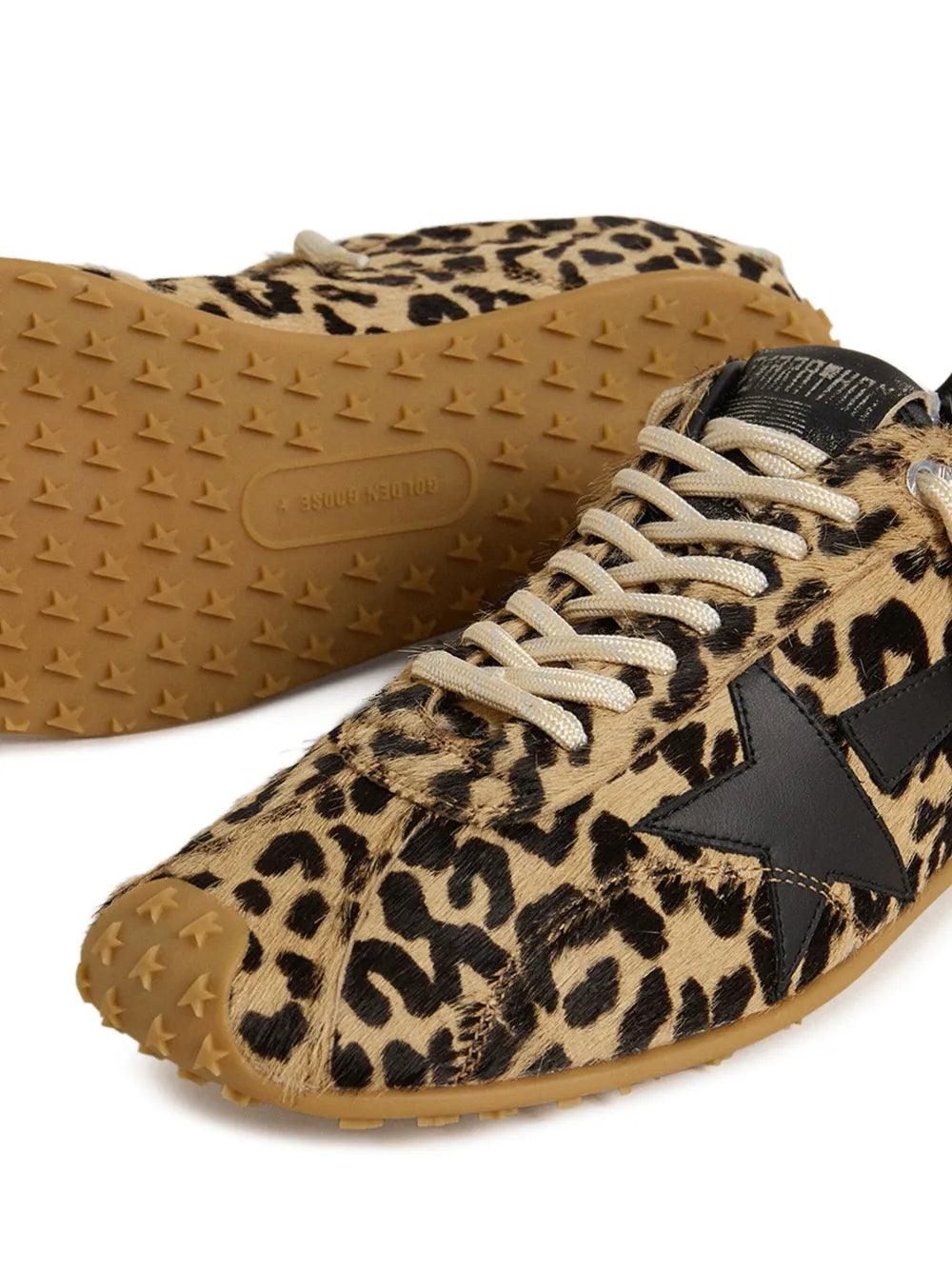 Beige leopard-print sneakers with black stripes and textured rubber sole