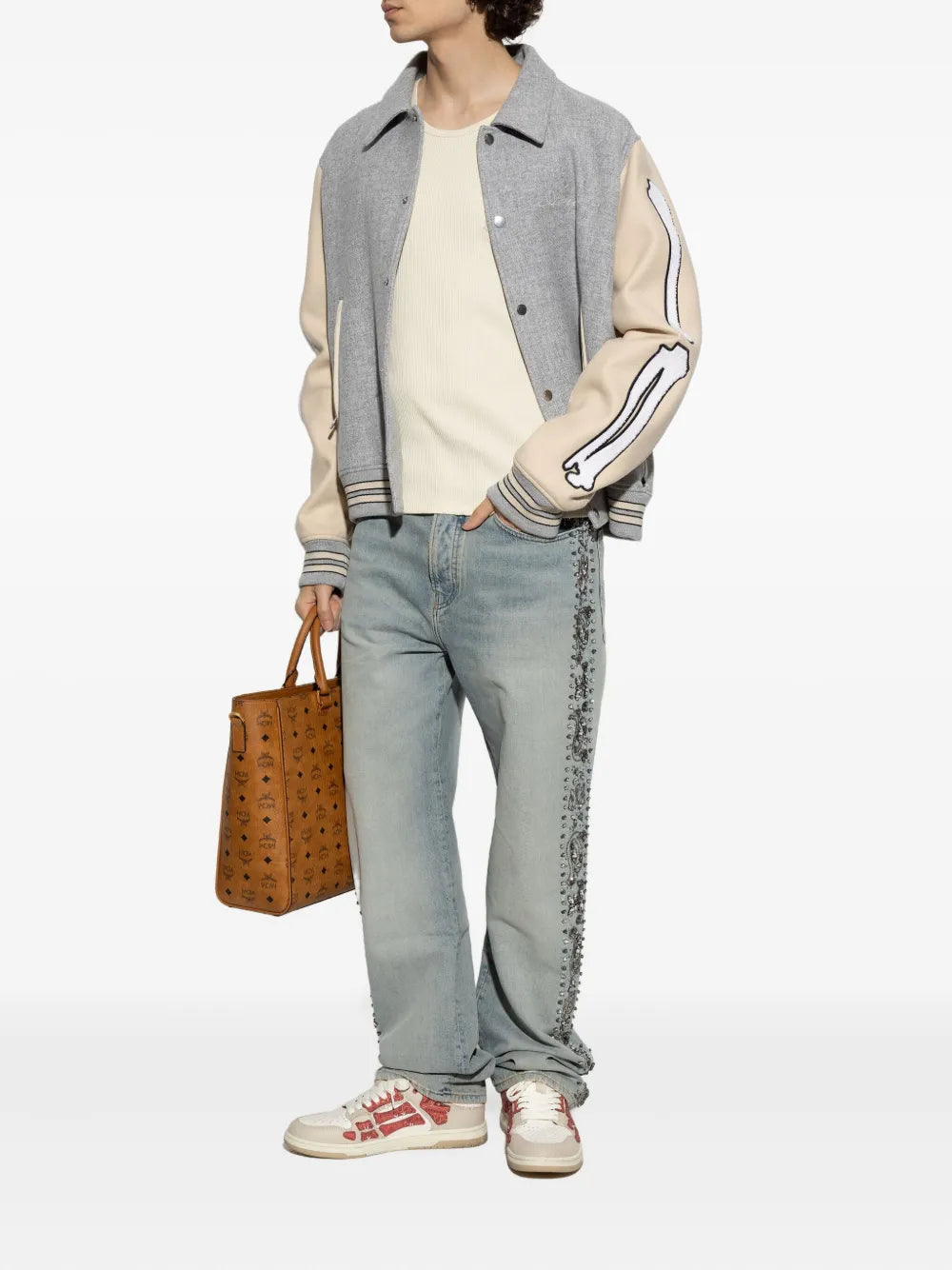 Low-top sneakers worn with light-wash jeans, red-and-white lace-up design