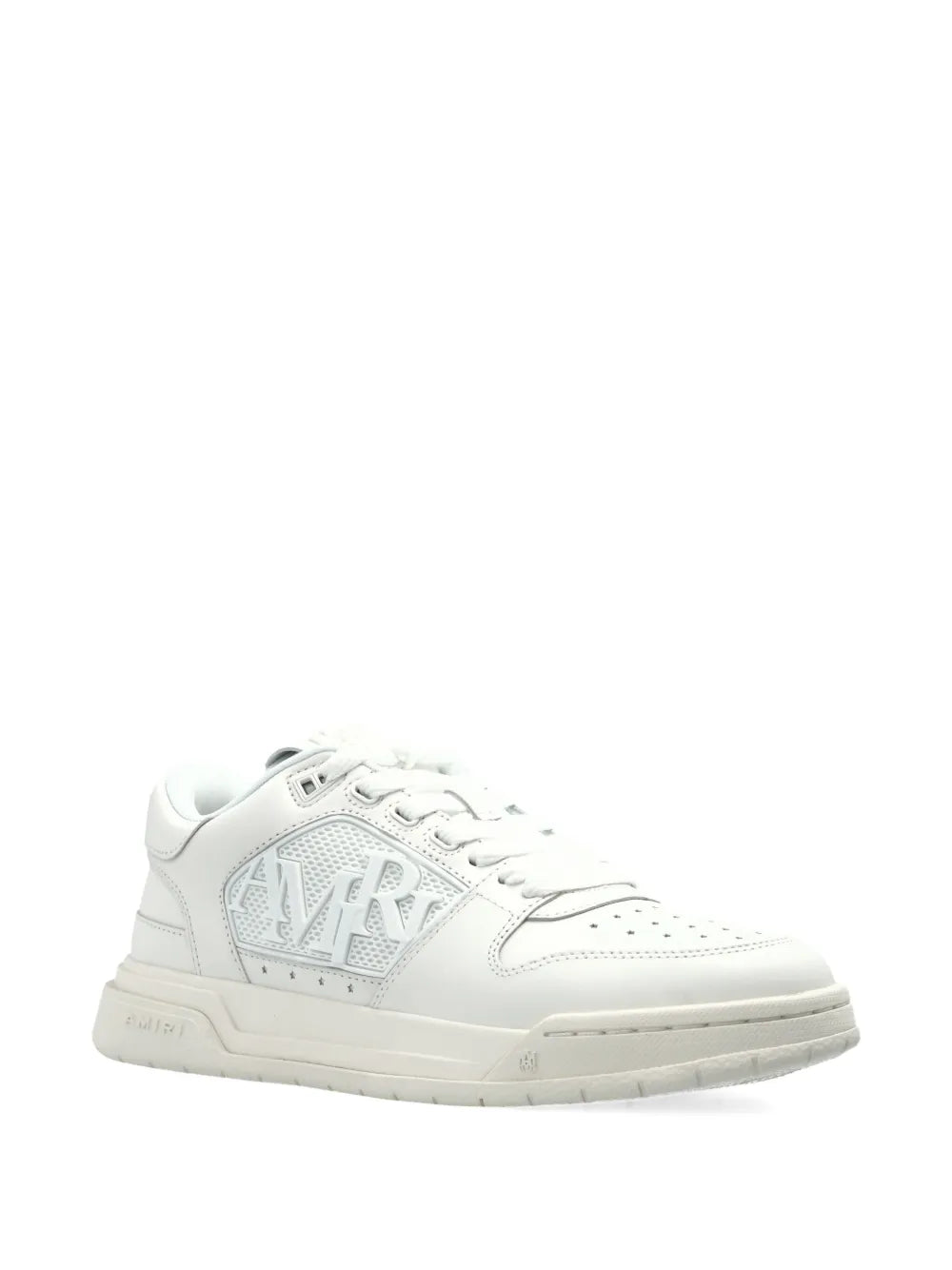 White low-top sneakers with embossed AMIRI logo on the side and rubber sole
