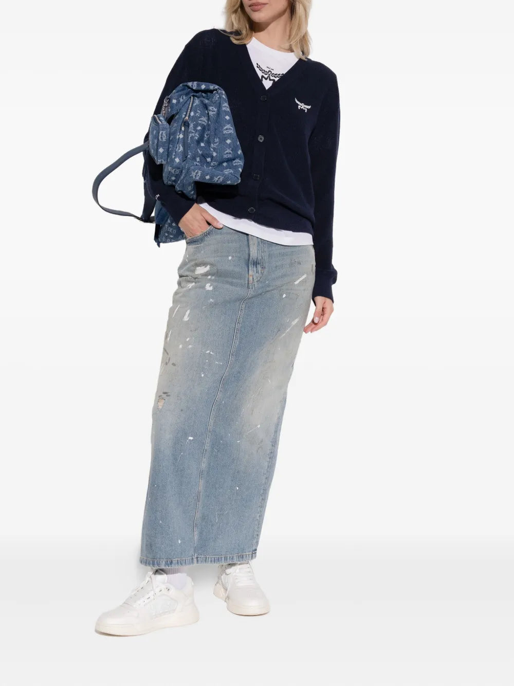 White low-top AMIRI logo-embellished sneakers worn with denim jeans