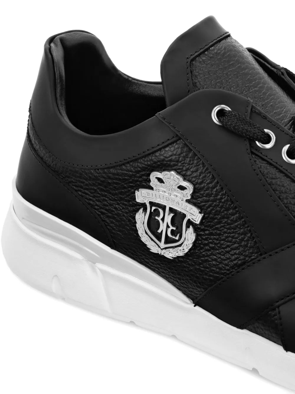 Black runner sneakers with textured side, crest logo, and white platform sole