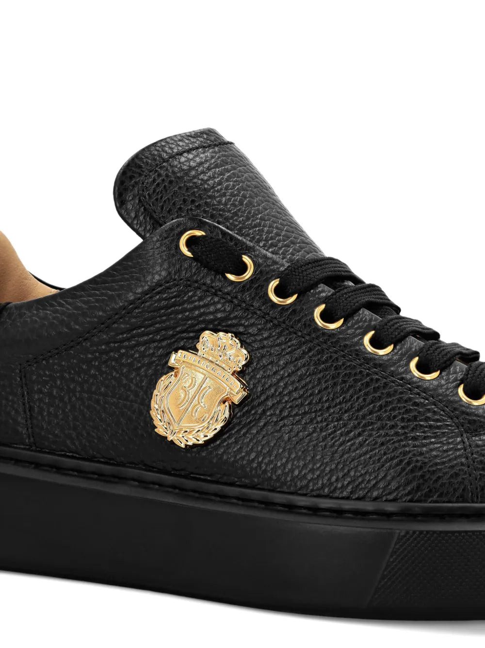 Black leather sneakers with gold logo plaque on side, lace-up and eyelets detail