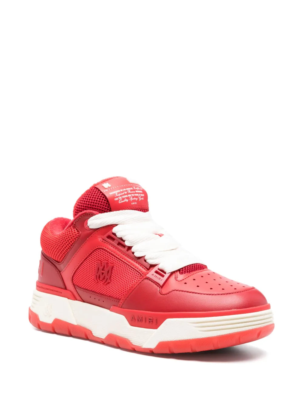 Red low-top sneakers with white laces, perforated toe, and chunky sole