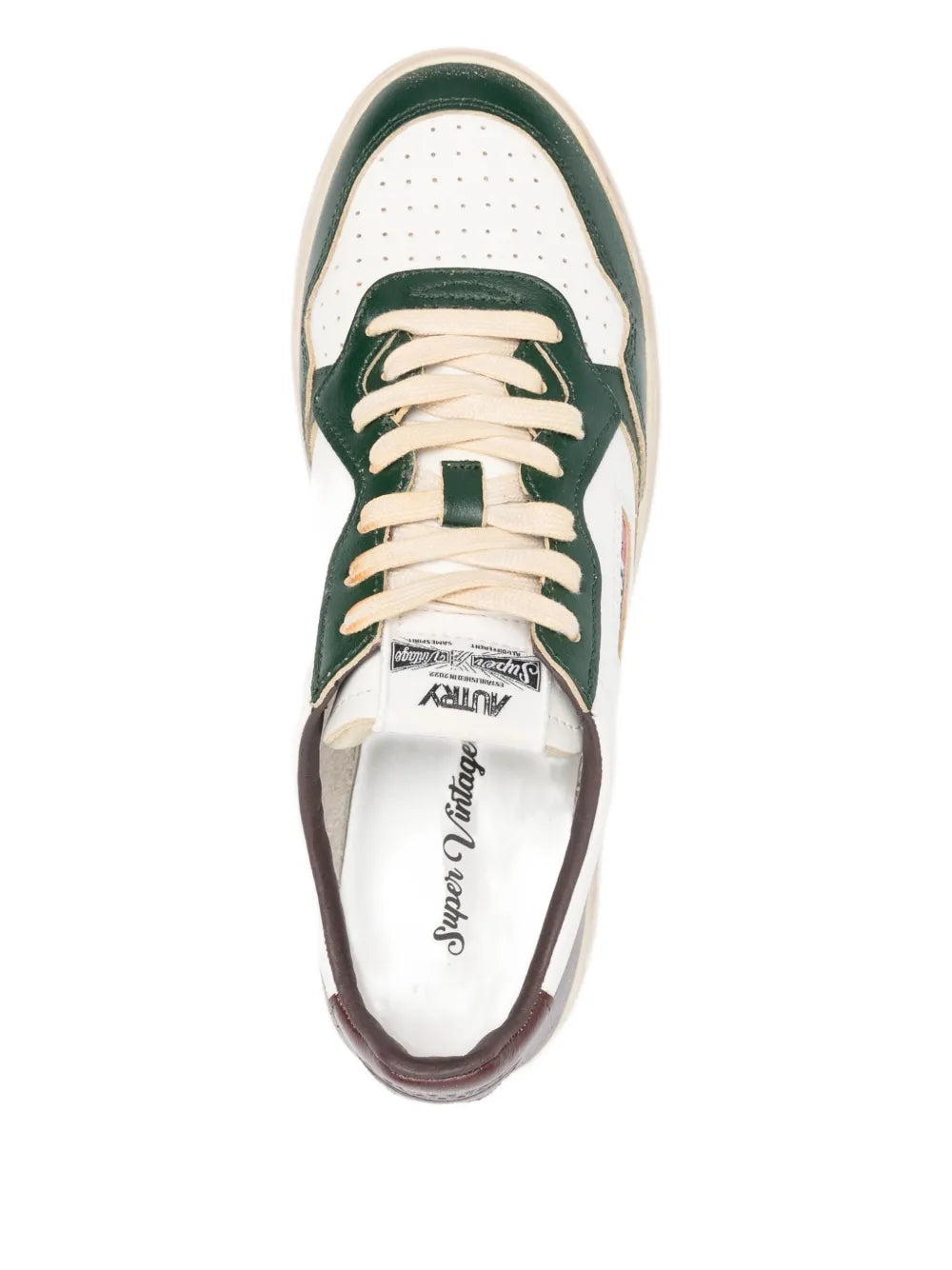 Lace-up sneaker with off-white leather upper, green tongue, and padded collar