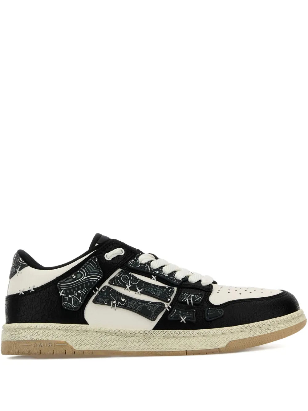 Black and off-white low-top sneakers with contrast panels, lace-up and logo detail