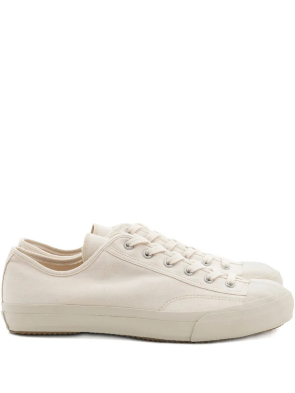 White canvas lace-up sneakers, low-profile with rubber toe and side stripe
