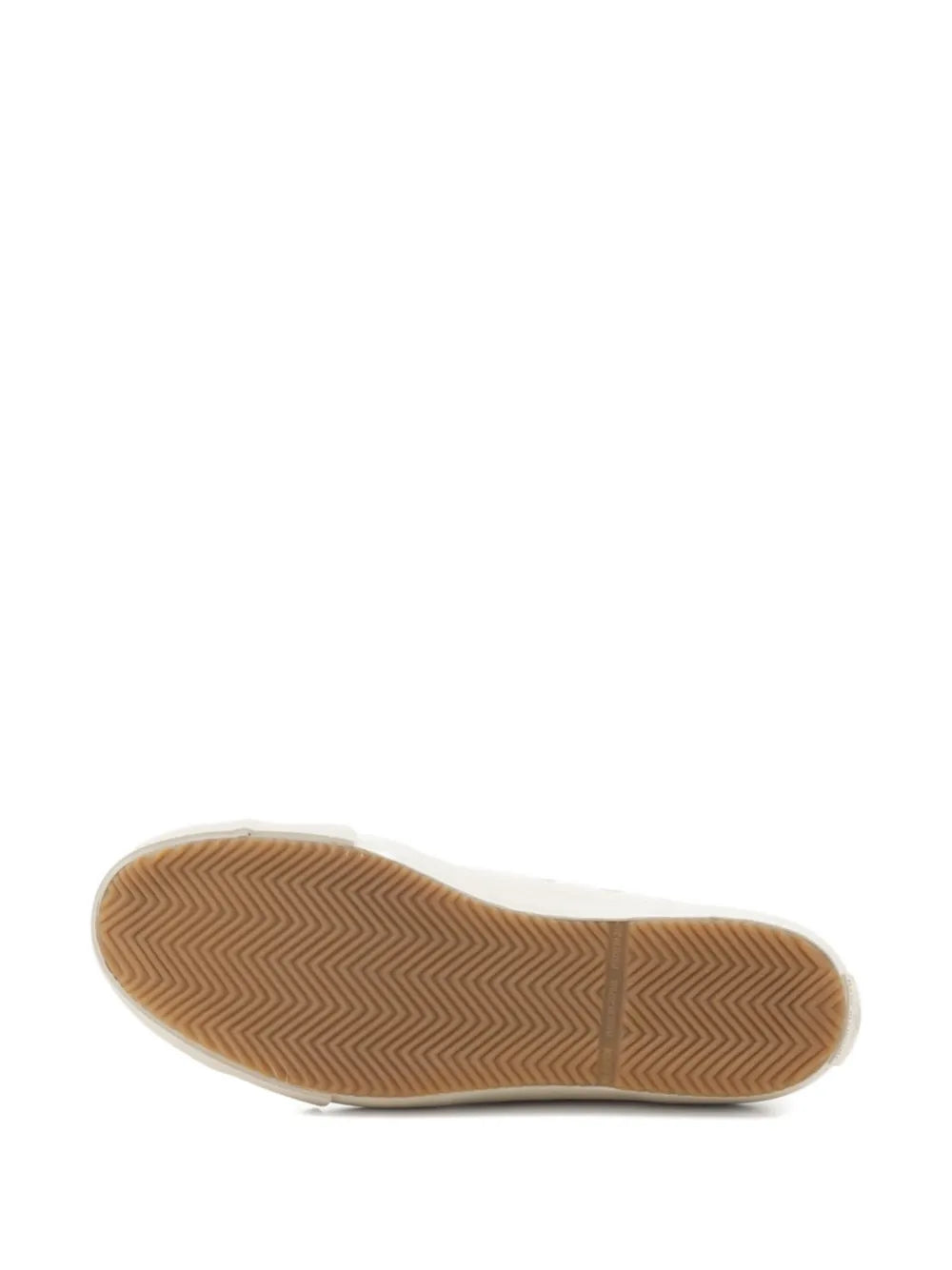 White rubber outsole of canvas lace-up sneakers with textured herringbone tread