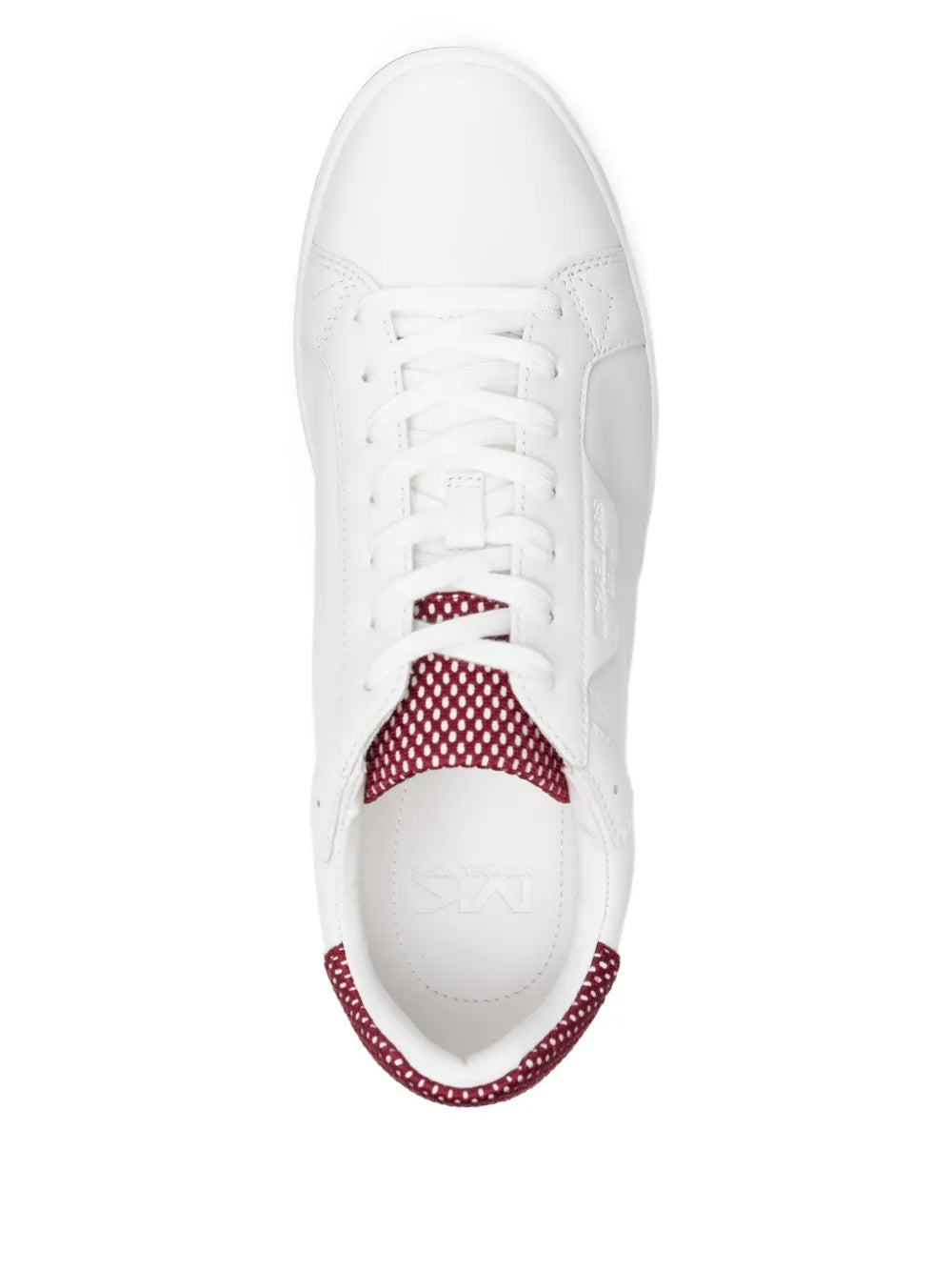 White sneakers with red polka-dot collar lining and lace-up front, side view