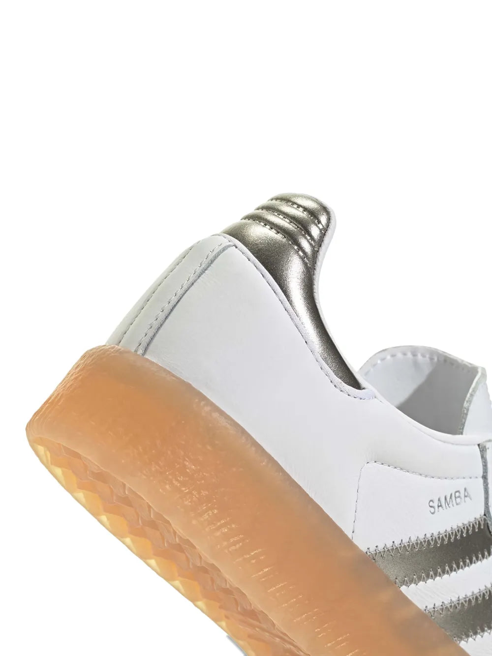 White low-top sneaker with metallic heel panel, padded collar, and gum sole