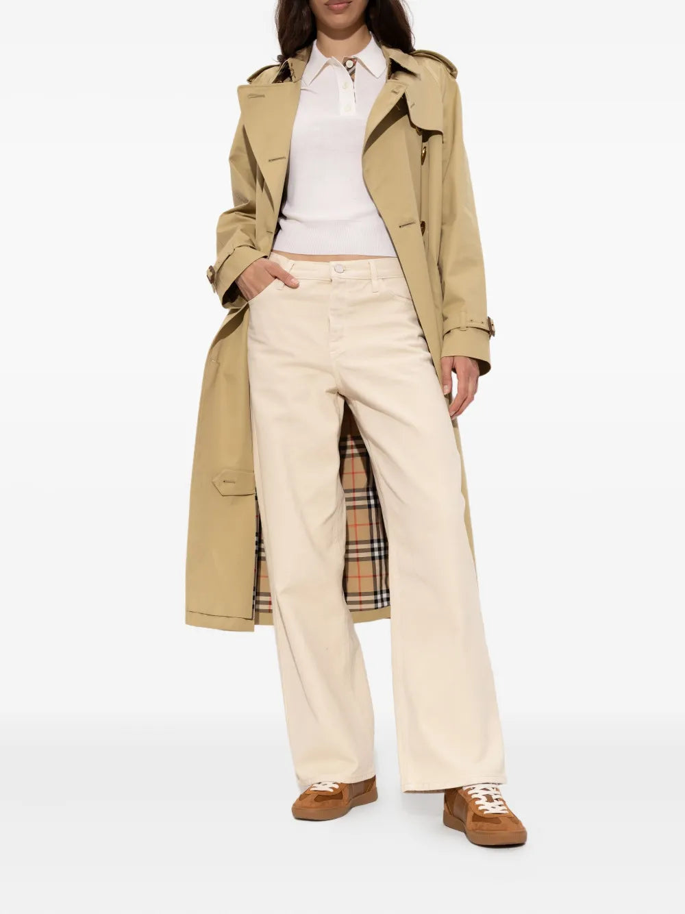 Brown COACH leather sneakers worn with beige trousers