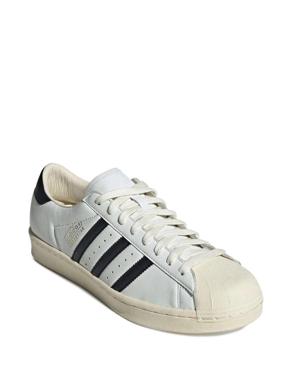 adidas low-top sneakers side profile, white leather with black stripes and cream lace-up sole