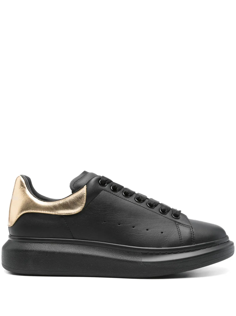 Black oversized leather sneaker, gold heel panel, lace-up with thick rubber sole