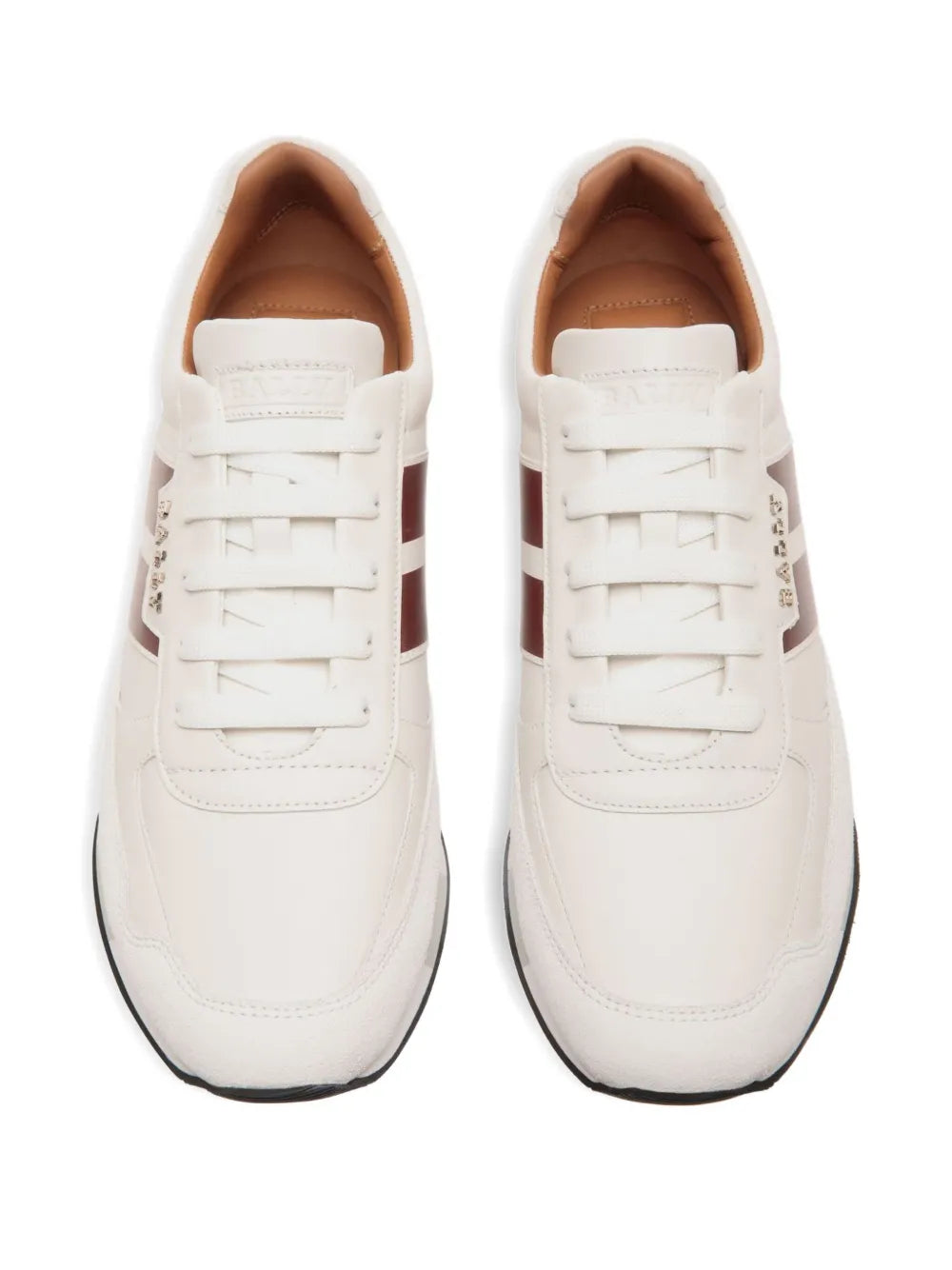 Pair of white leather low-top sneakers showing lace-up fronts and tan-lined interiors