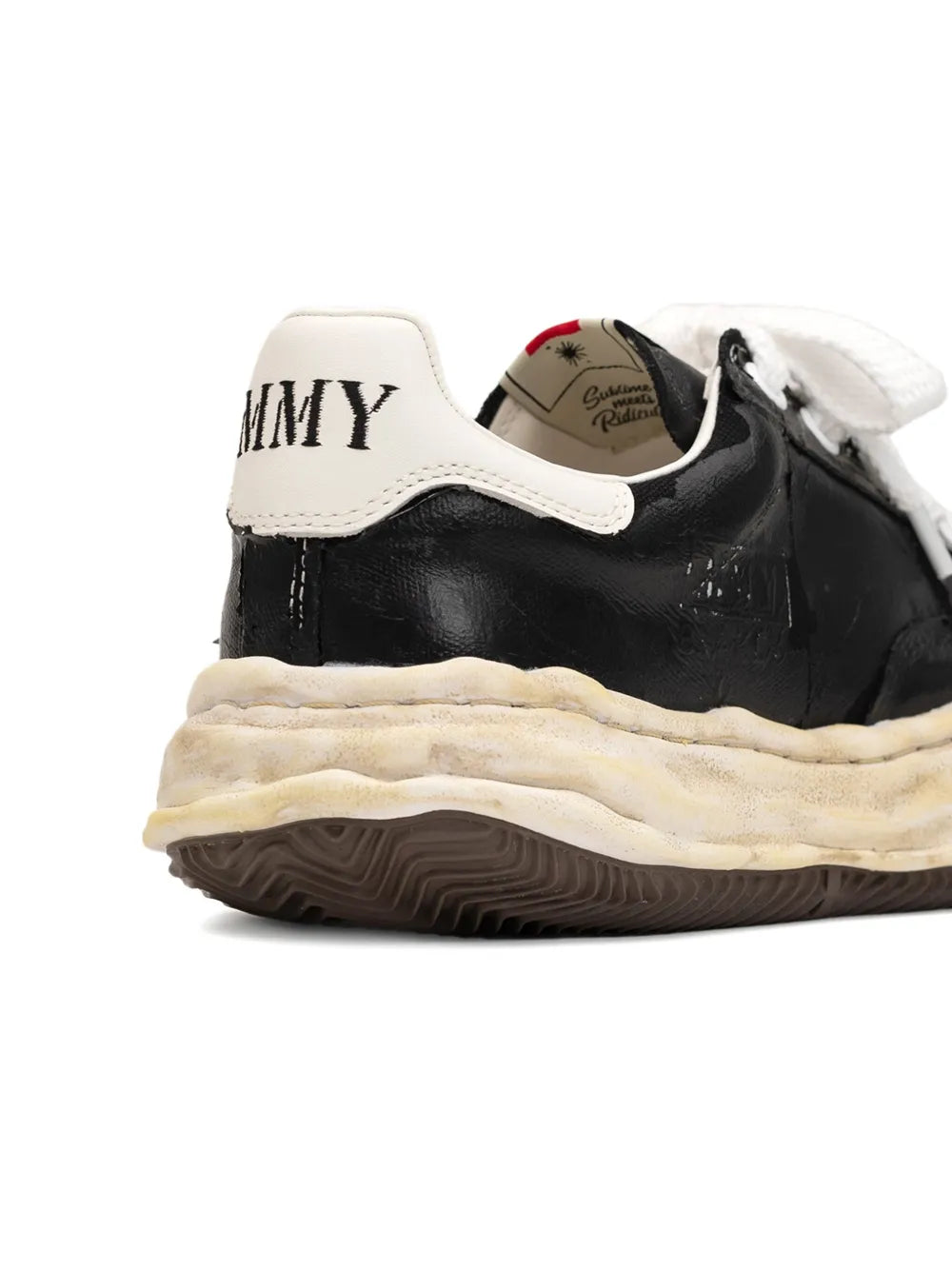 Black and cream low-top sneakers with white heel tab and padded collar