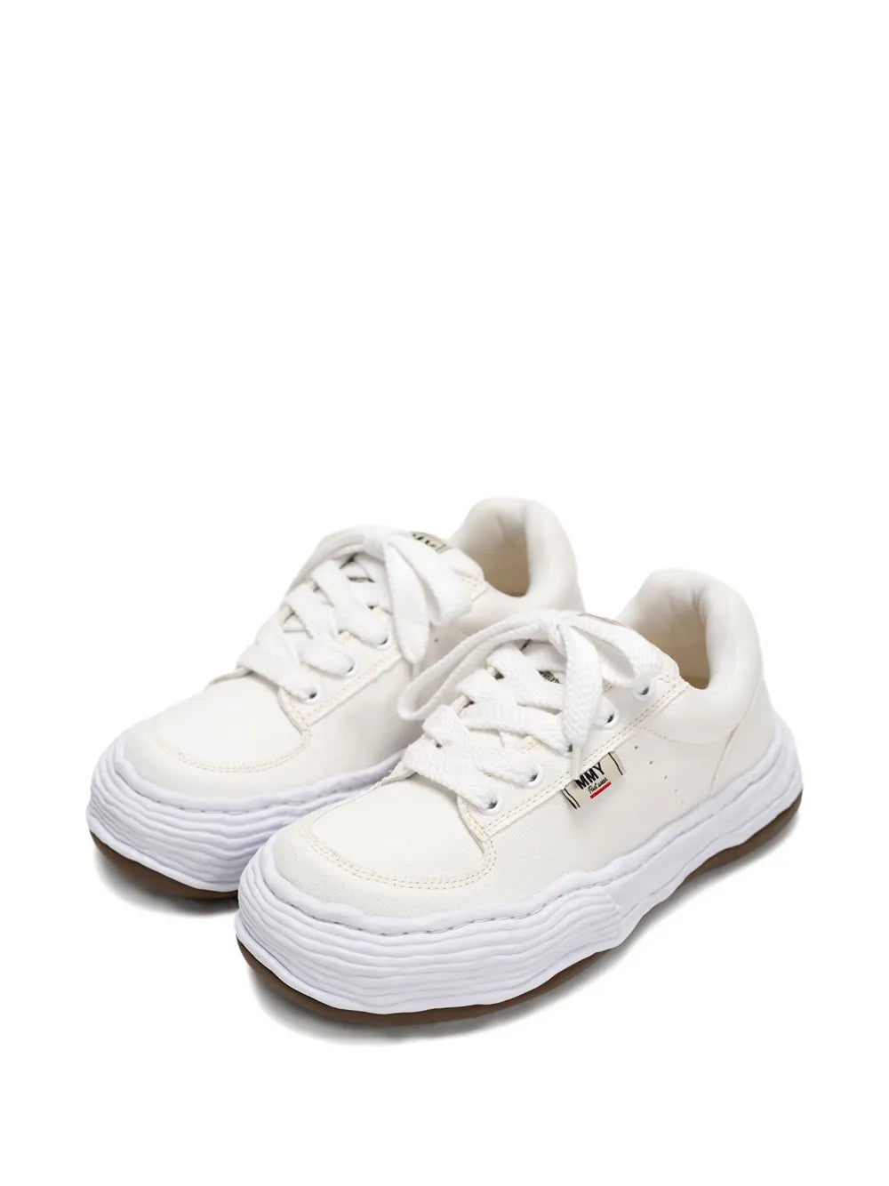 White canvas lace-up sneakers, side view with wavy platform sole