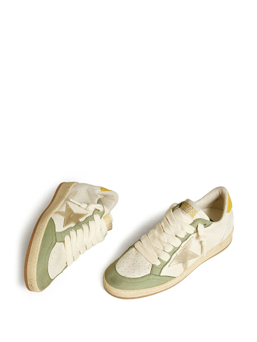 Pair of white leather lace-up sneakers with green inserts and yellow heel tab