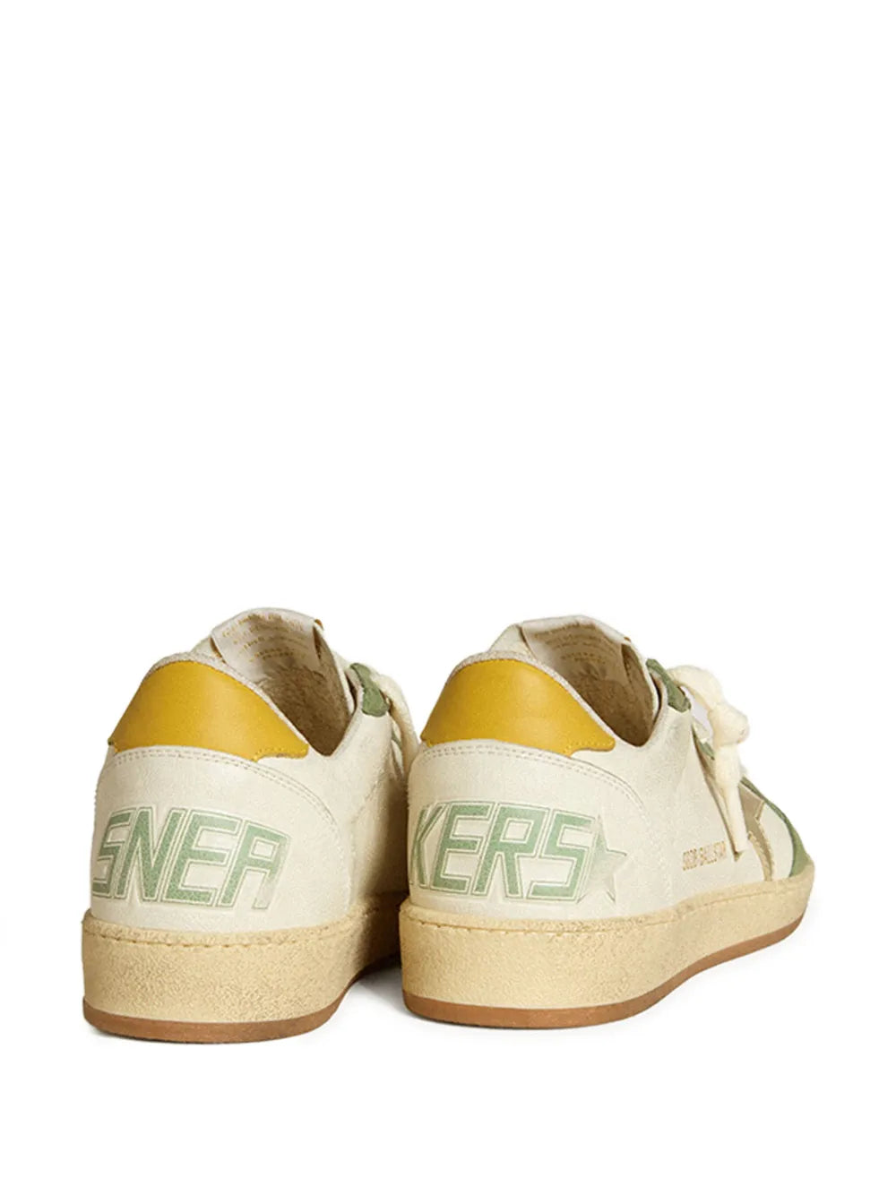 Back view of white leather sneaker with green heel logo and yellow collar lining