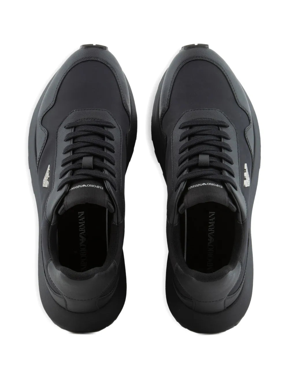 Black lace-up sneakers viewed from the front with molded toe and laces.