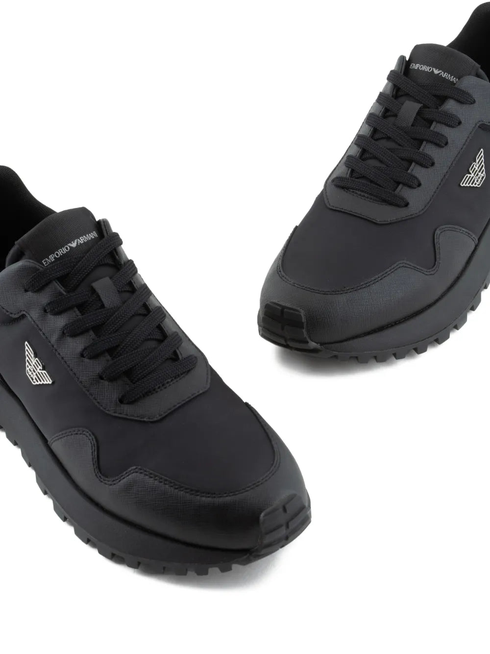 Black lace-up sneakers with side logo plaque and textured rubber outsole.
