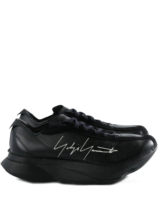 Black leather lace-up trainers, signature-style side graphic, thick sole.