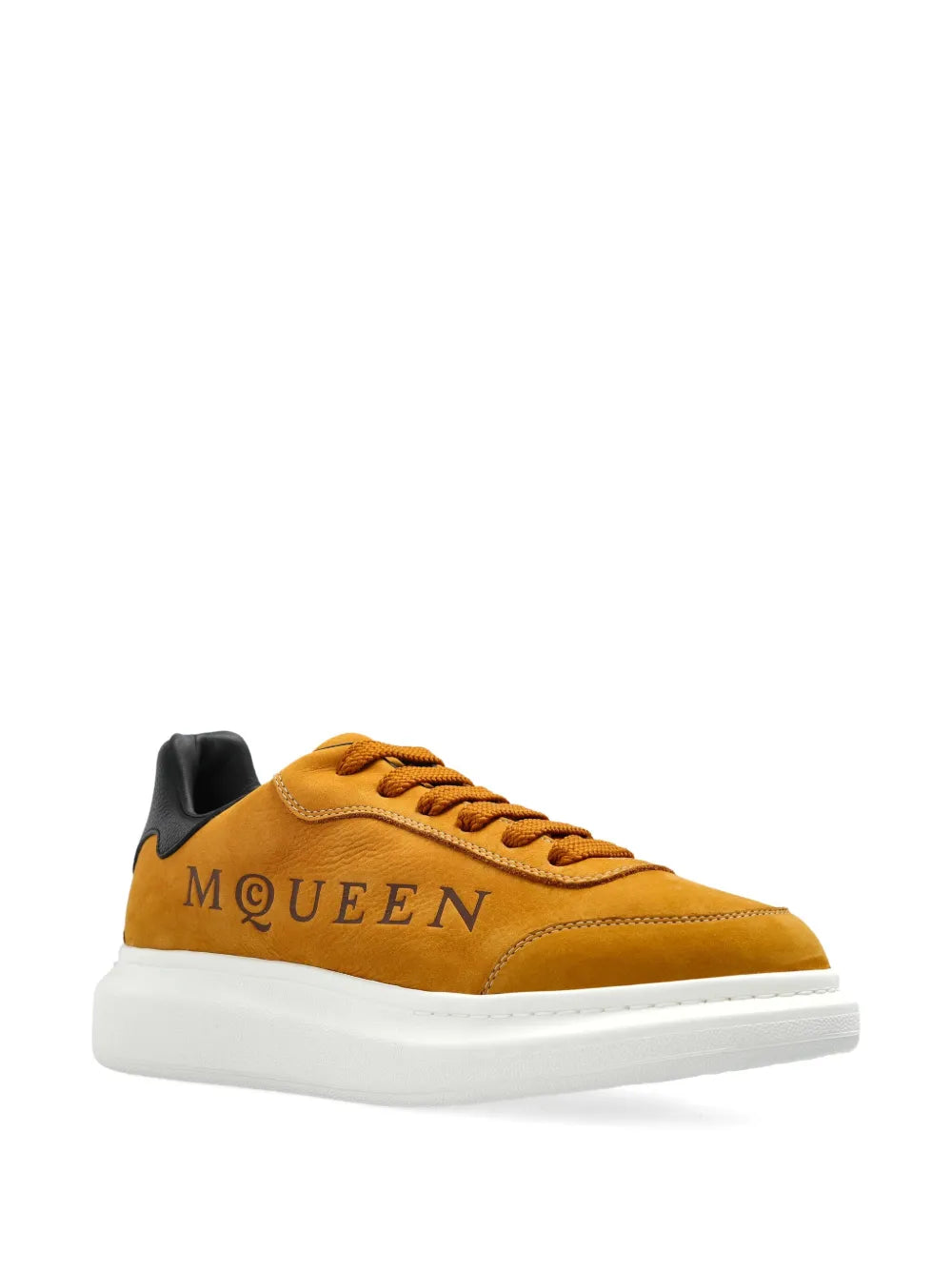 Golden brown oversized sneakers with black back tab and embroidered MQ logo