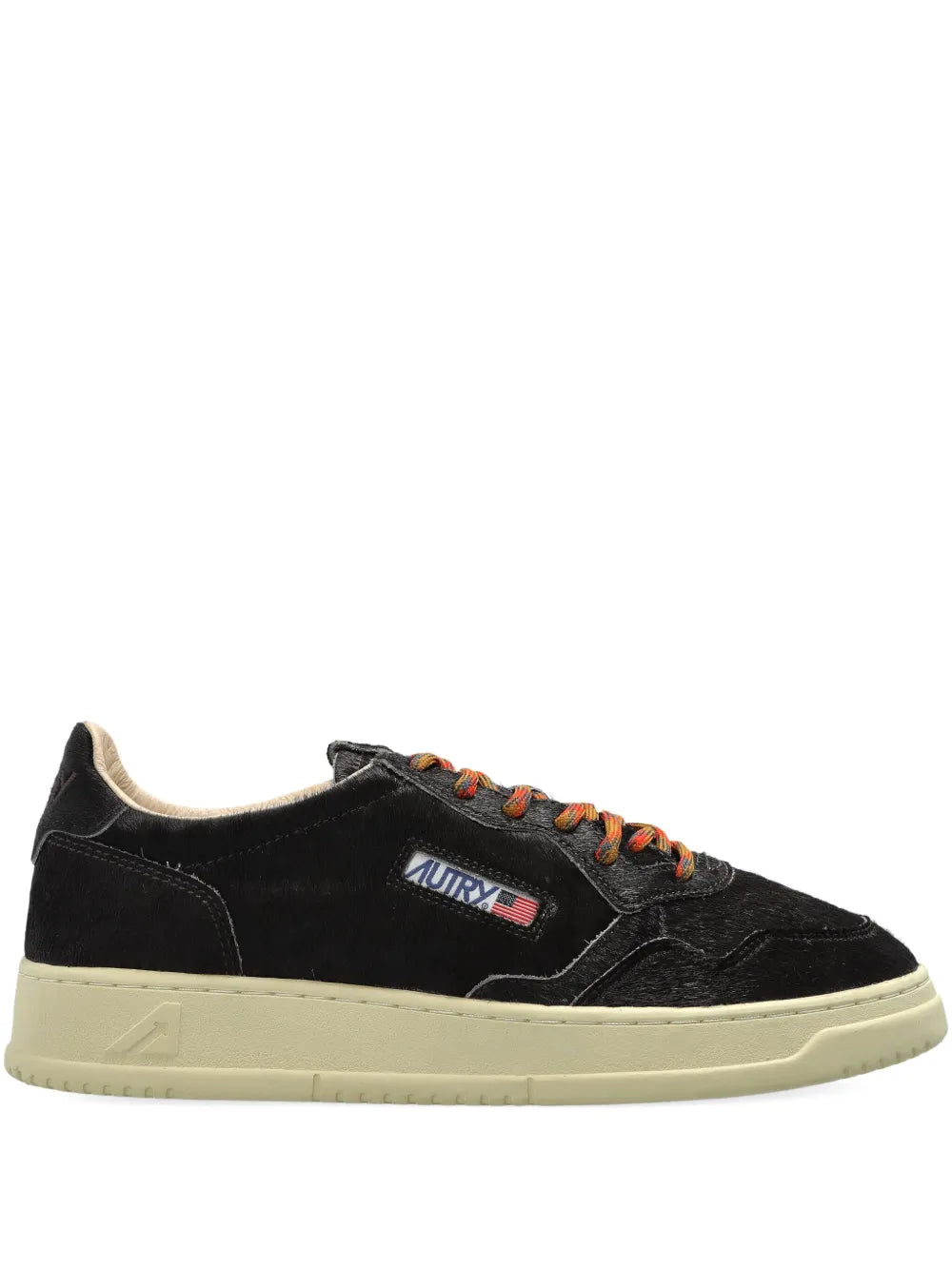 Black suede low-top sneakers with orange lace-up and cream rubber sole