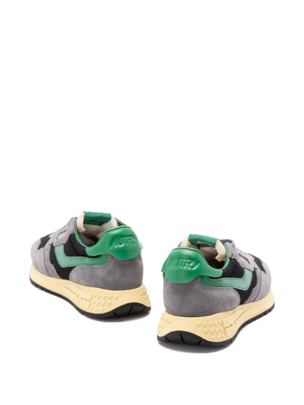 Back view of grey low-top sneakers with green heel tabs and lace-up closure.