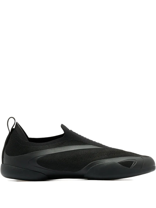 Black slip-on sneaker with mesh upper and sculpted rubber sole