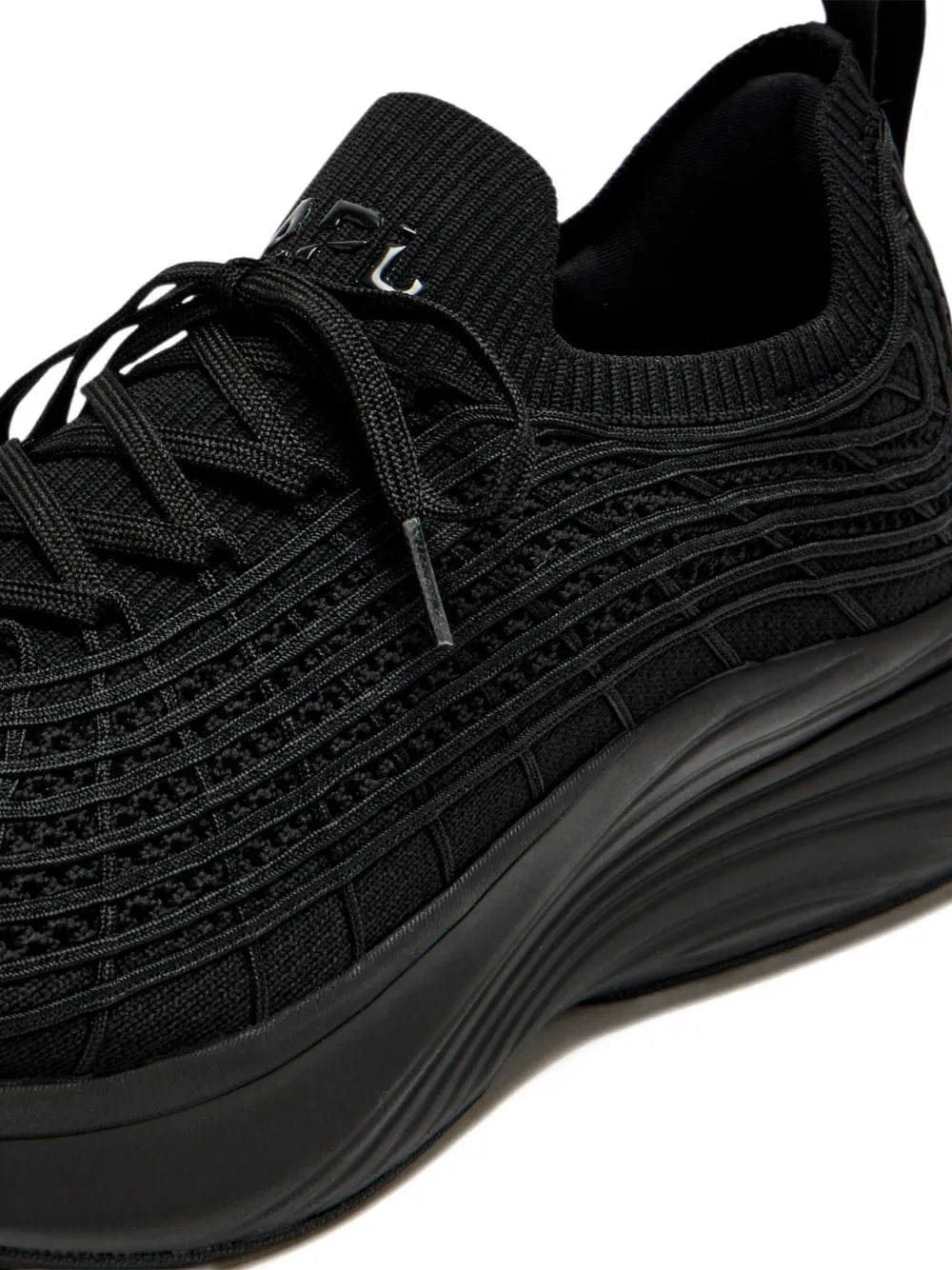 Close-up of black textured knit upper on lace-up sneakers