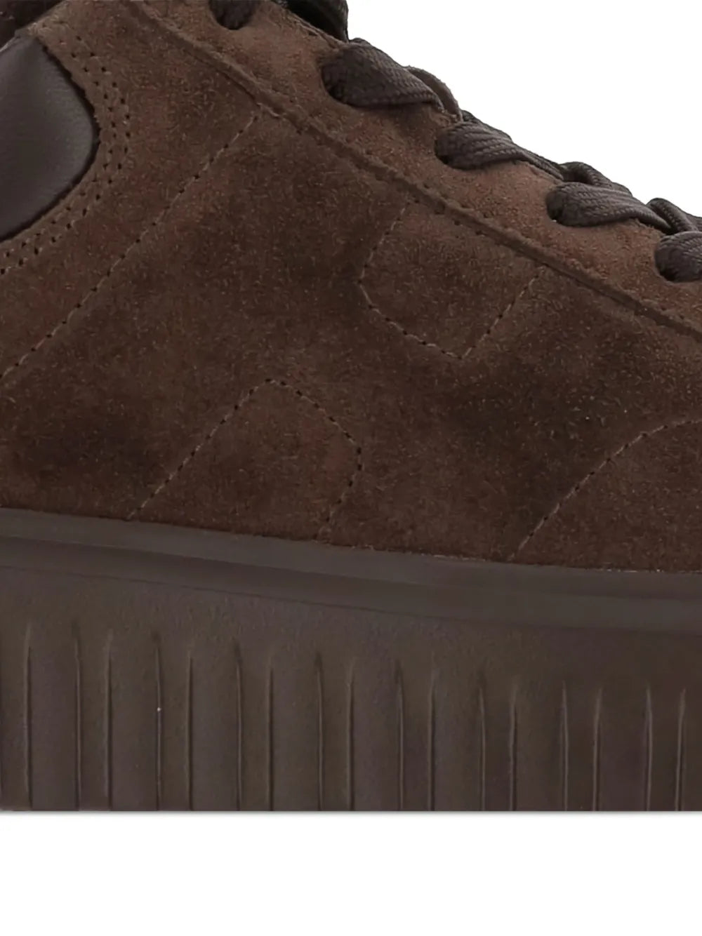 Dark brown suede sneaker upper with lace eyelets and stitched panel seams