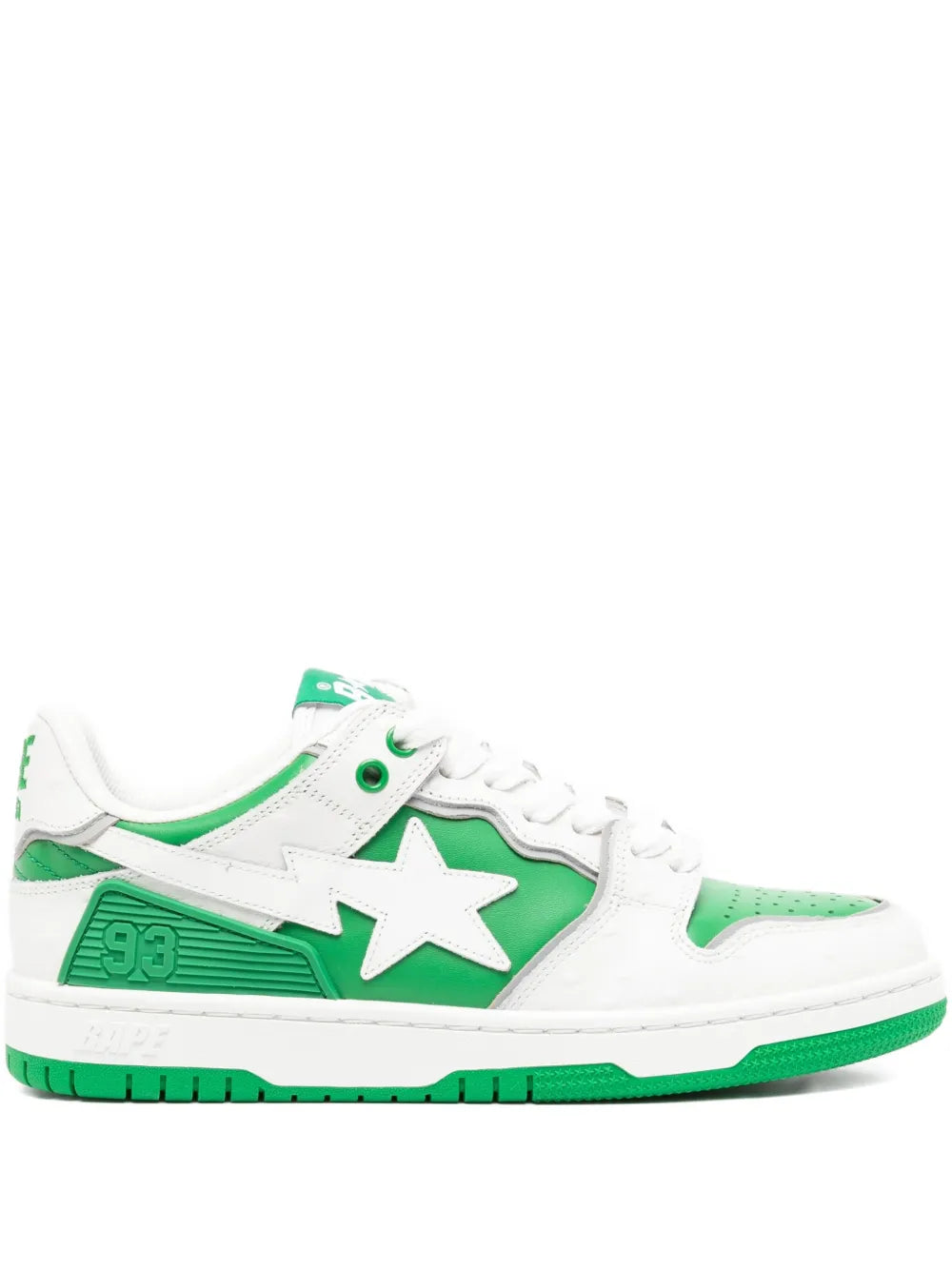 White low-top sneakers with green star applique and contrast green rubber sole