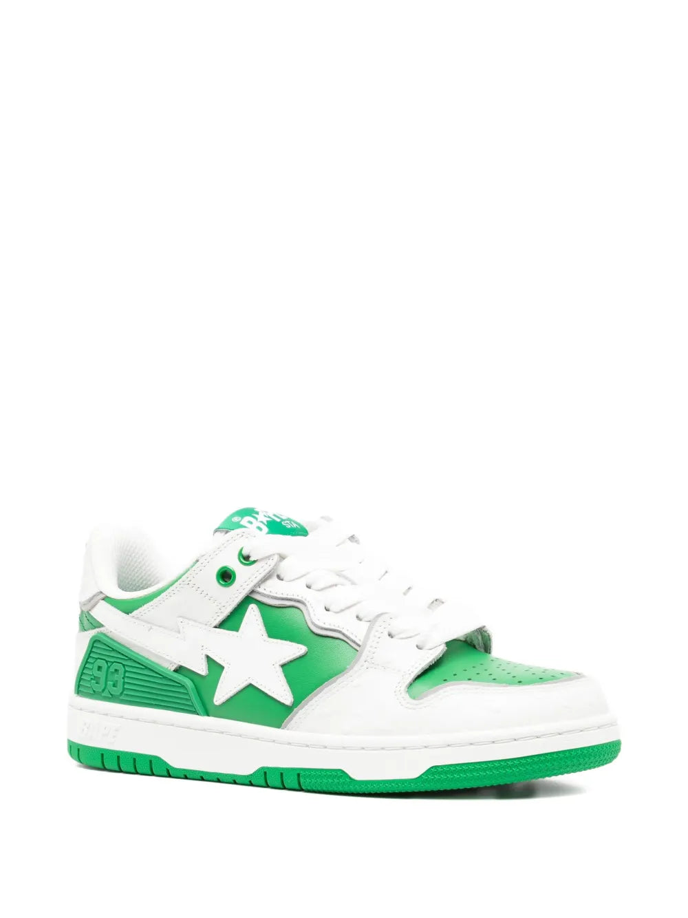 White low-top sneakers with green quarter panels and large star emblem, green sole