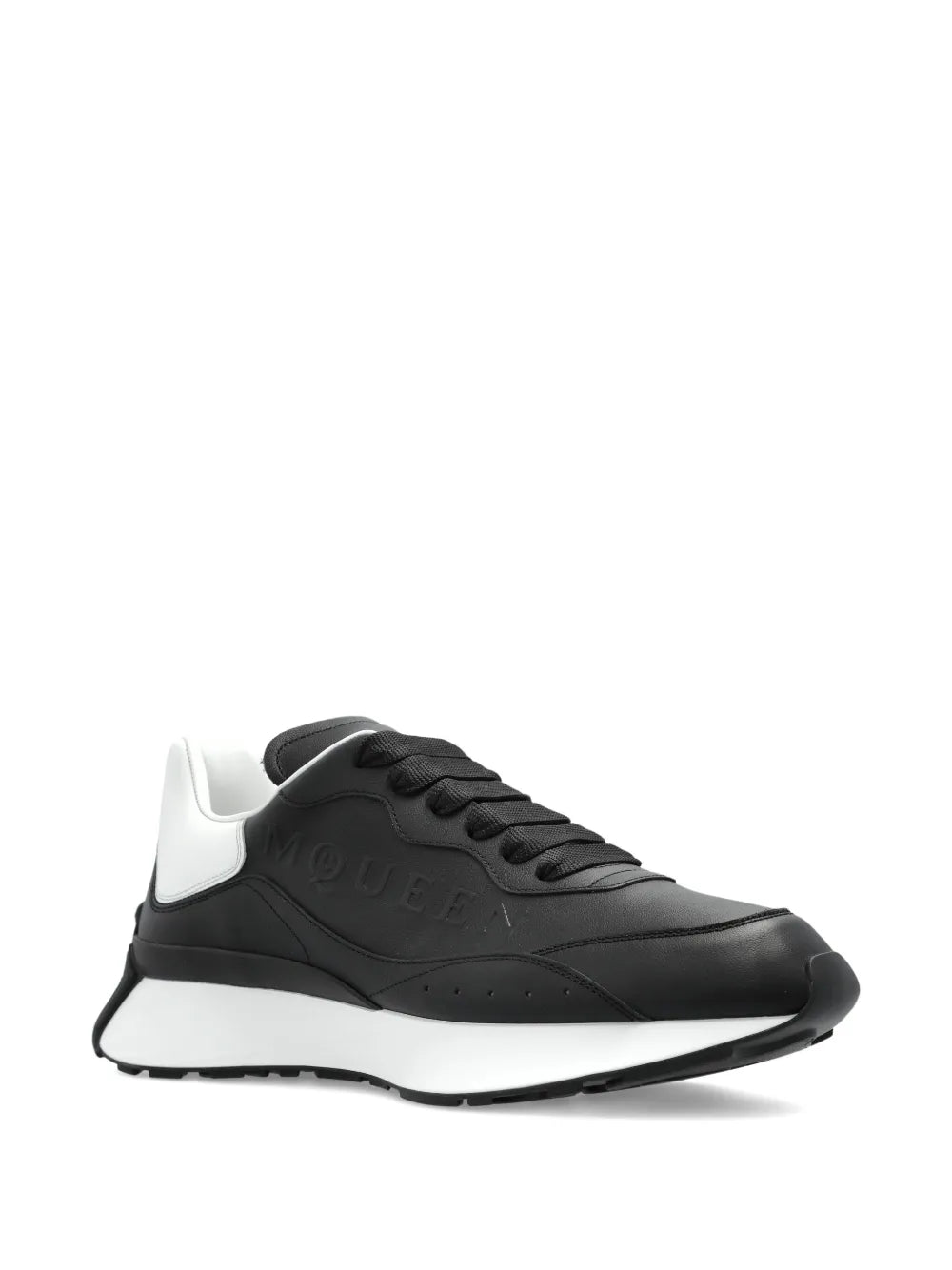 Black leather lace-up trainers, side view with embossed logo and white rubber sole
