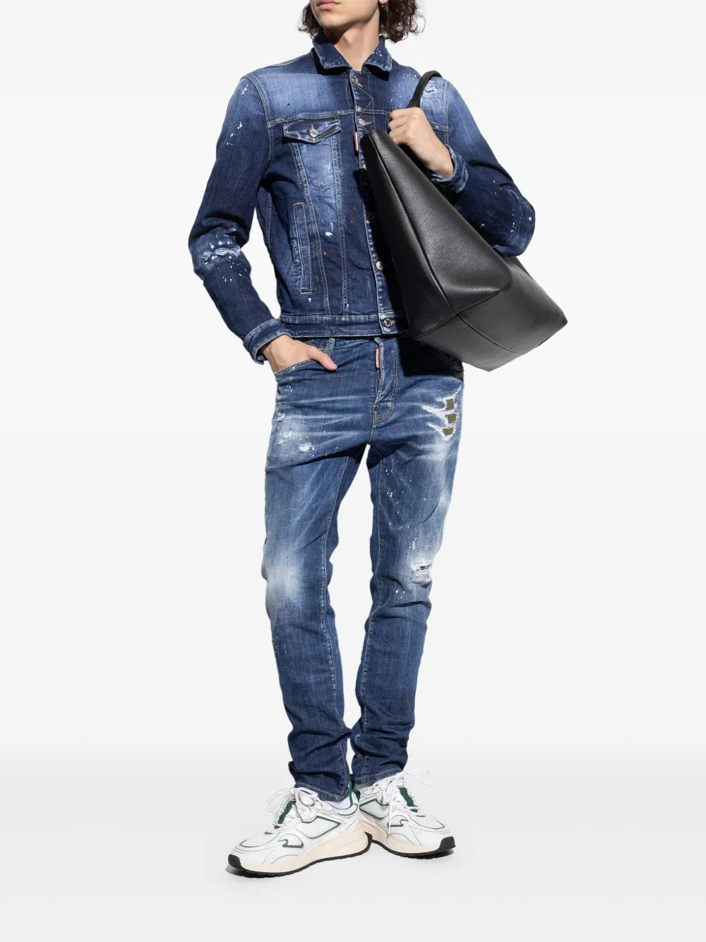 Dsquared2 leaf-detail sneakers worn with blue jeans; white uppers with green accents