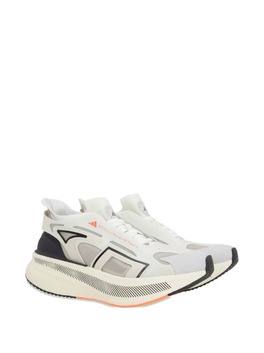White mesh sneaker with black side panel and gray graphics, orange accent stripes