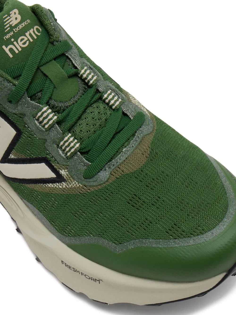 Green New Balance sneaker closeup with N side logo, laces, and Fresh Foam X midsole