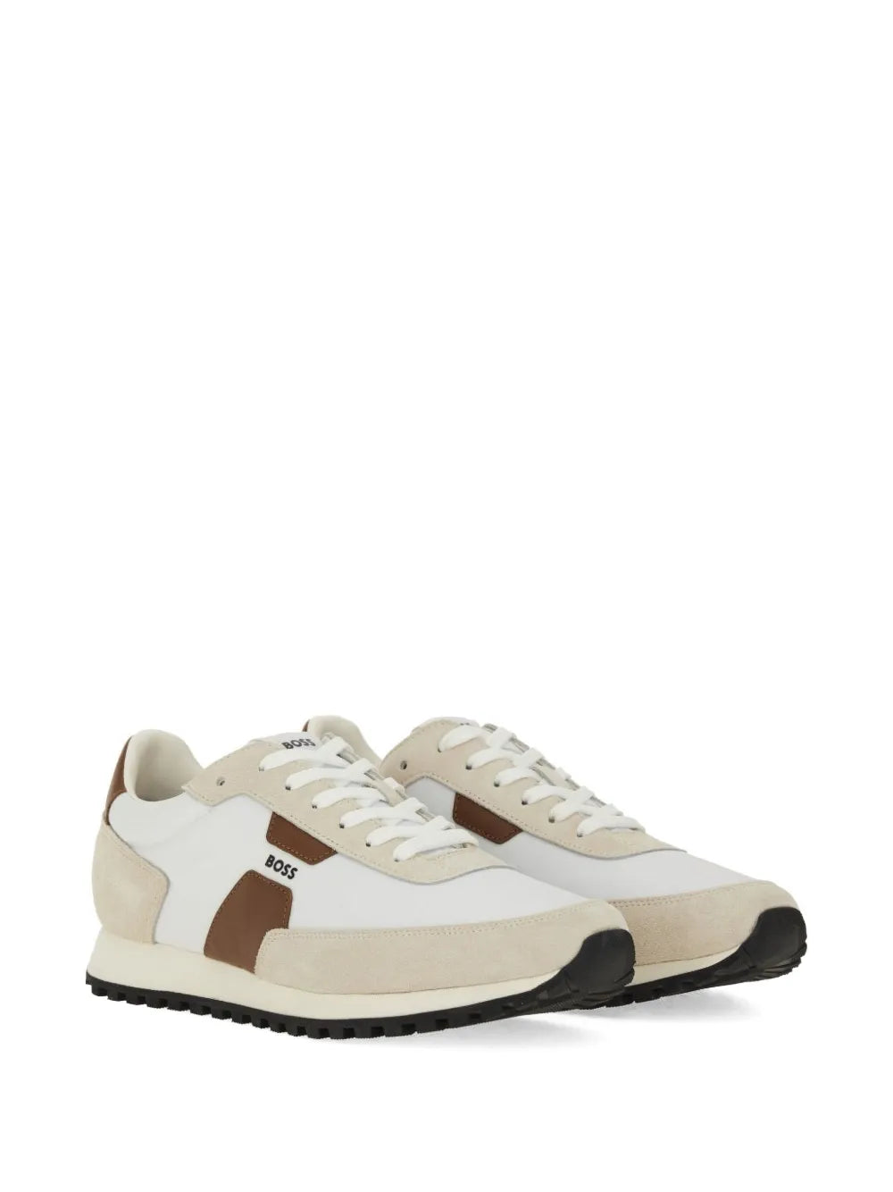Beige panelled low-top sneakers with white laces, brown straps, and thick black sole