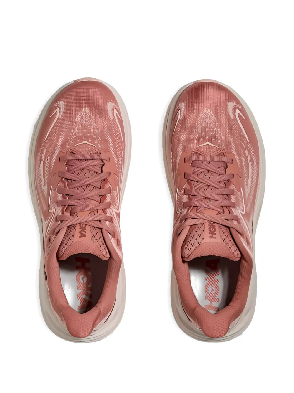 Pair of Hoka lace-up sneakers in blush pink with white midsoles and laces