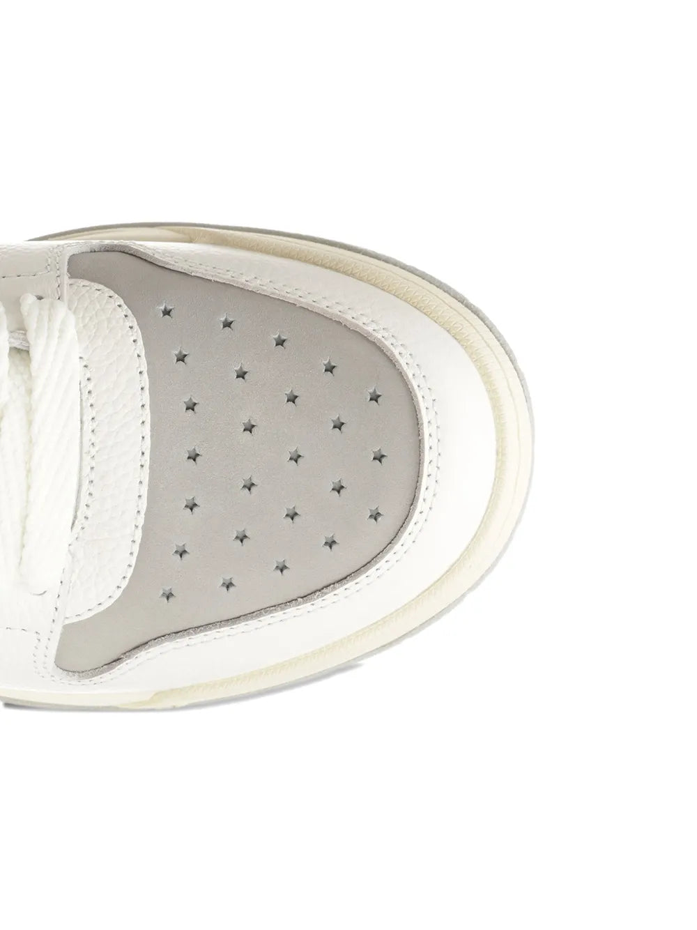 Light grey leather sneaker lining with star-pattern overlay and stitched edge