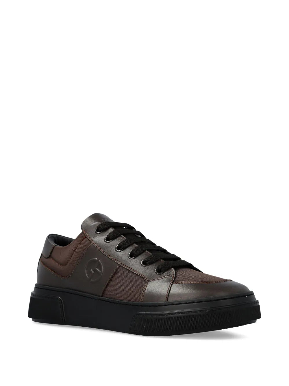 Brown leather low-top sneakers with laces, side logo, and black rubber sole