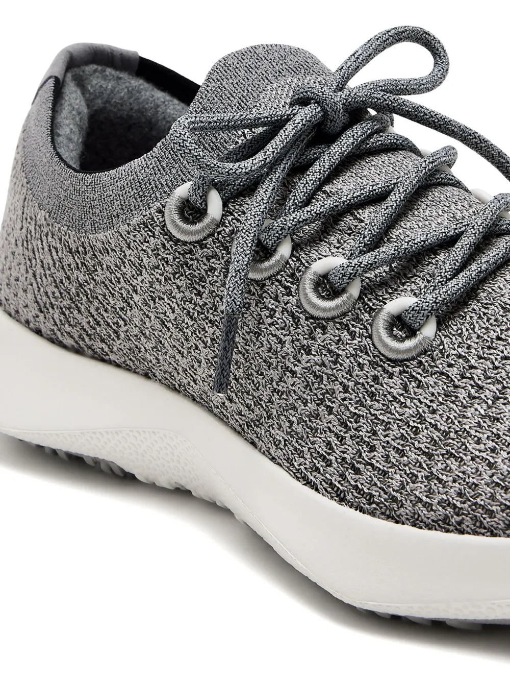 Close-up of medium grey knit lace-up sneaker upper with metal eyelets