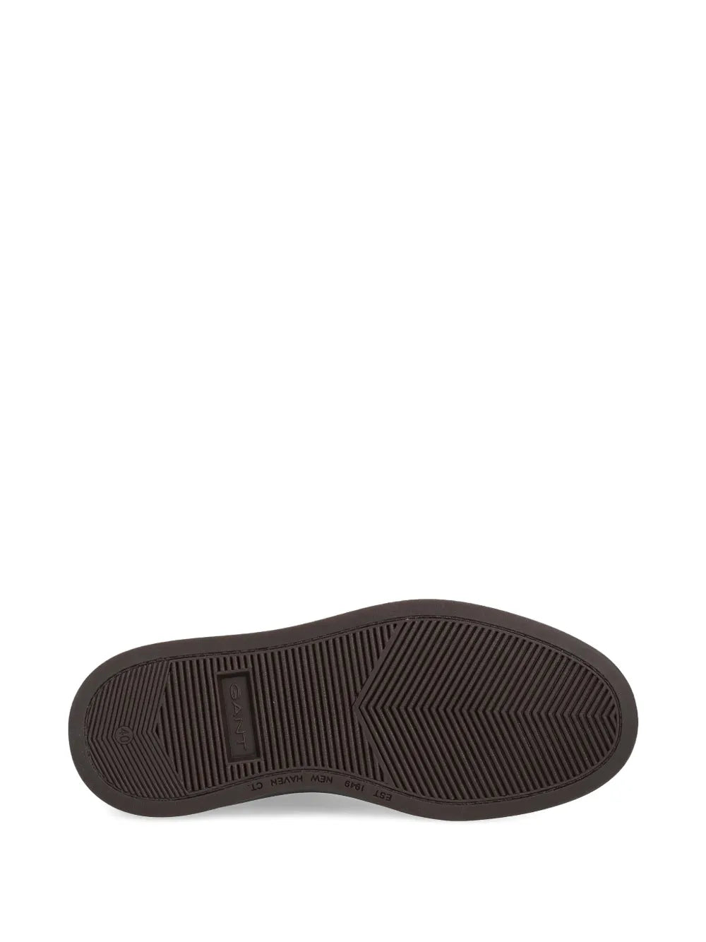 Rubber outsole for dark brown suede sneakers with textured tread pattern