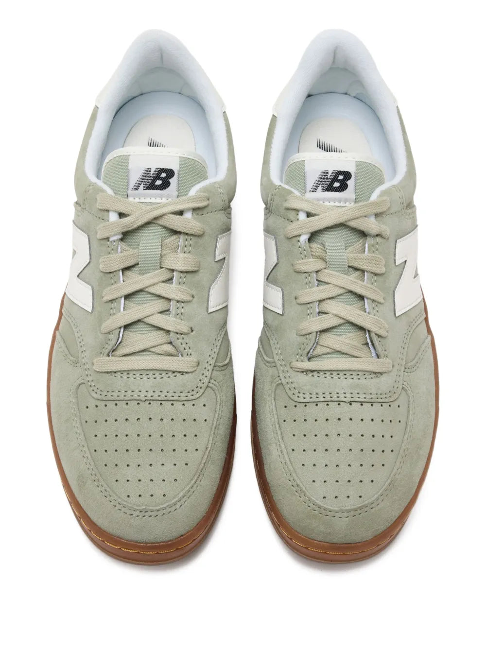 Sage green suede leather sneakers, white New Balance branding on tongue, lace-up front
