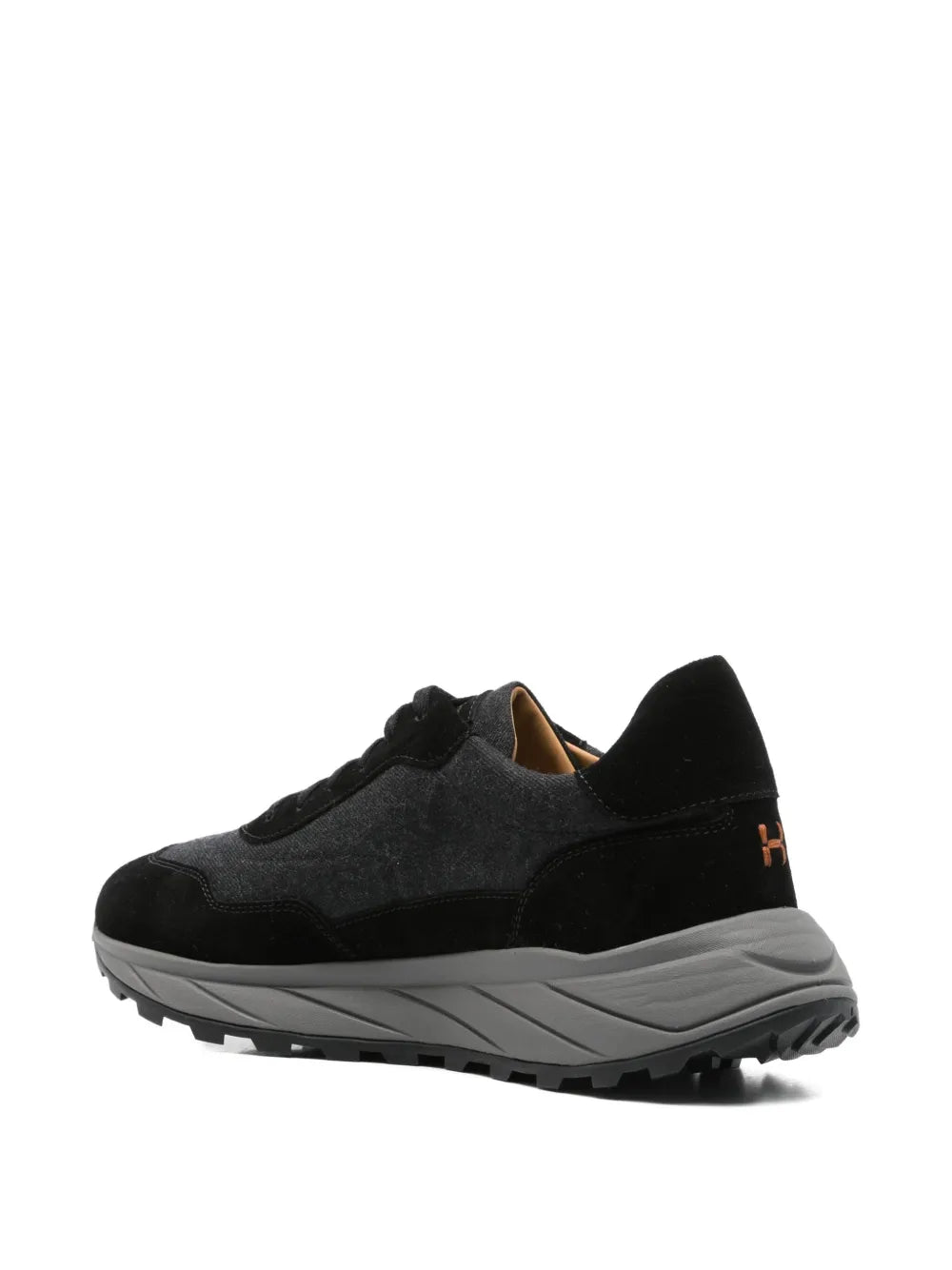 Black lace-up low-top sneakers with orange-lined collar and rugged tread sole