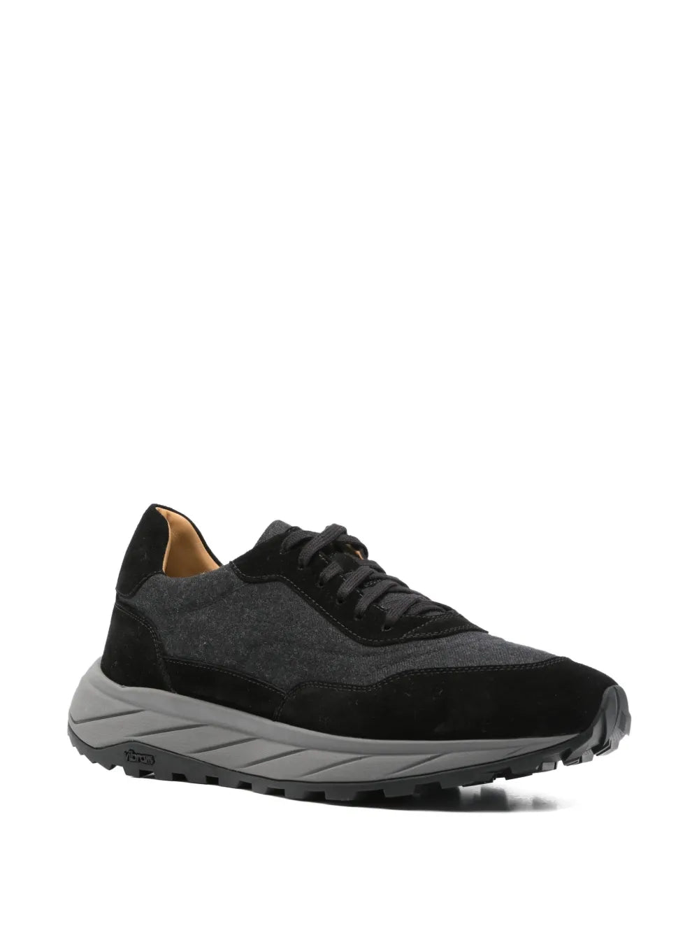 Black lace-up sneakers, side profile, chunky tread sole and gray midsole