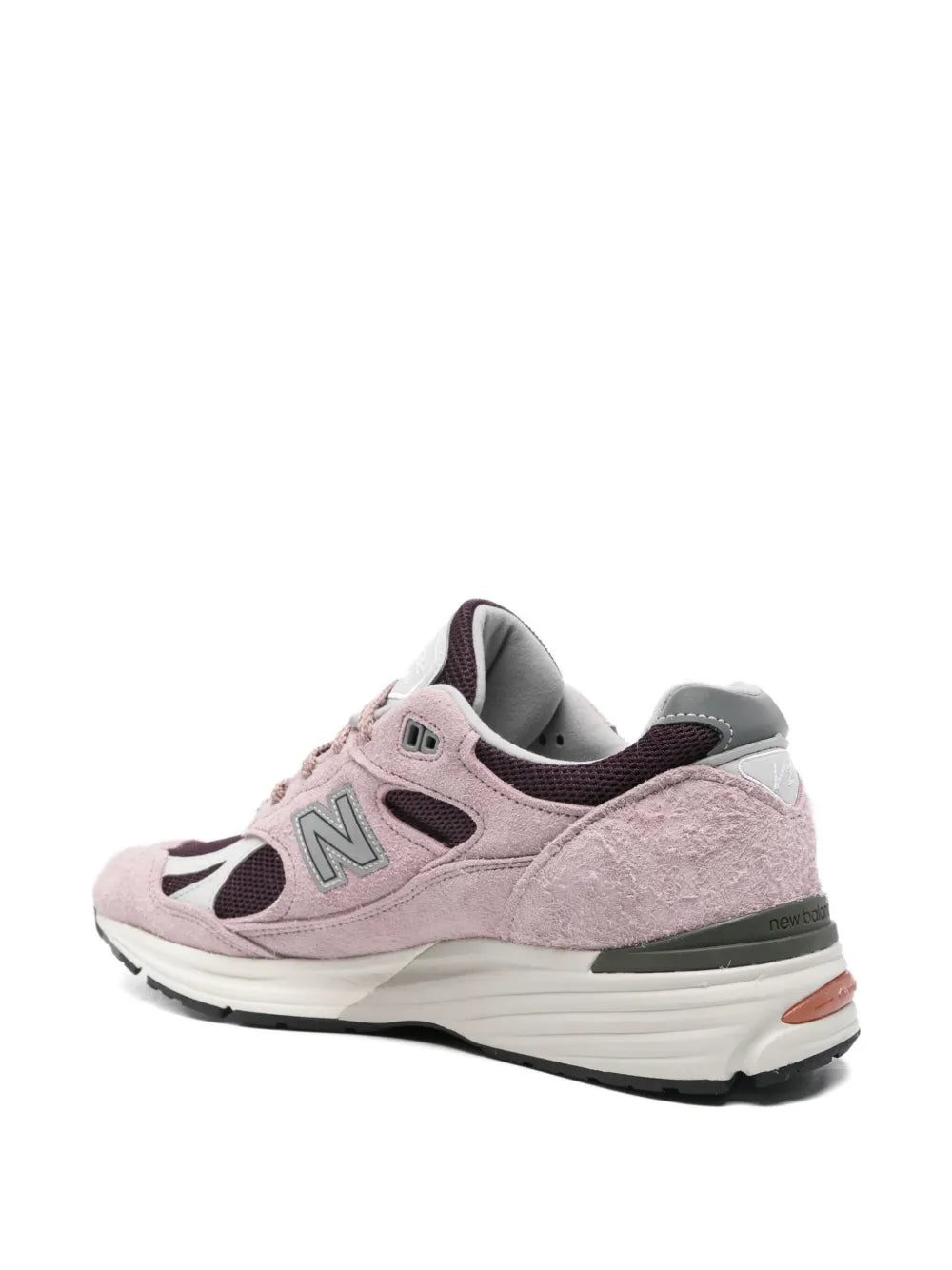 Pink suede New Balance 991 sneakers rear view with cushioned heel and dark trim