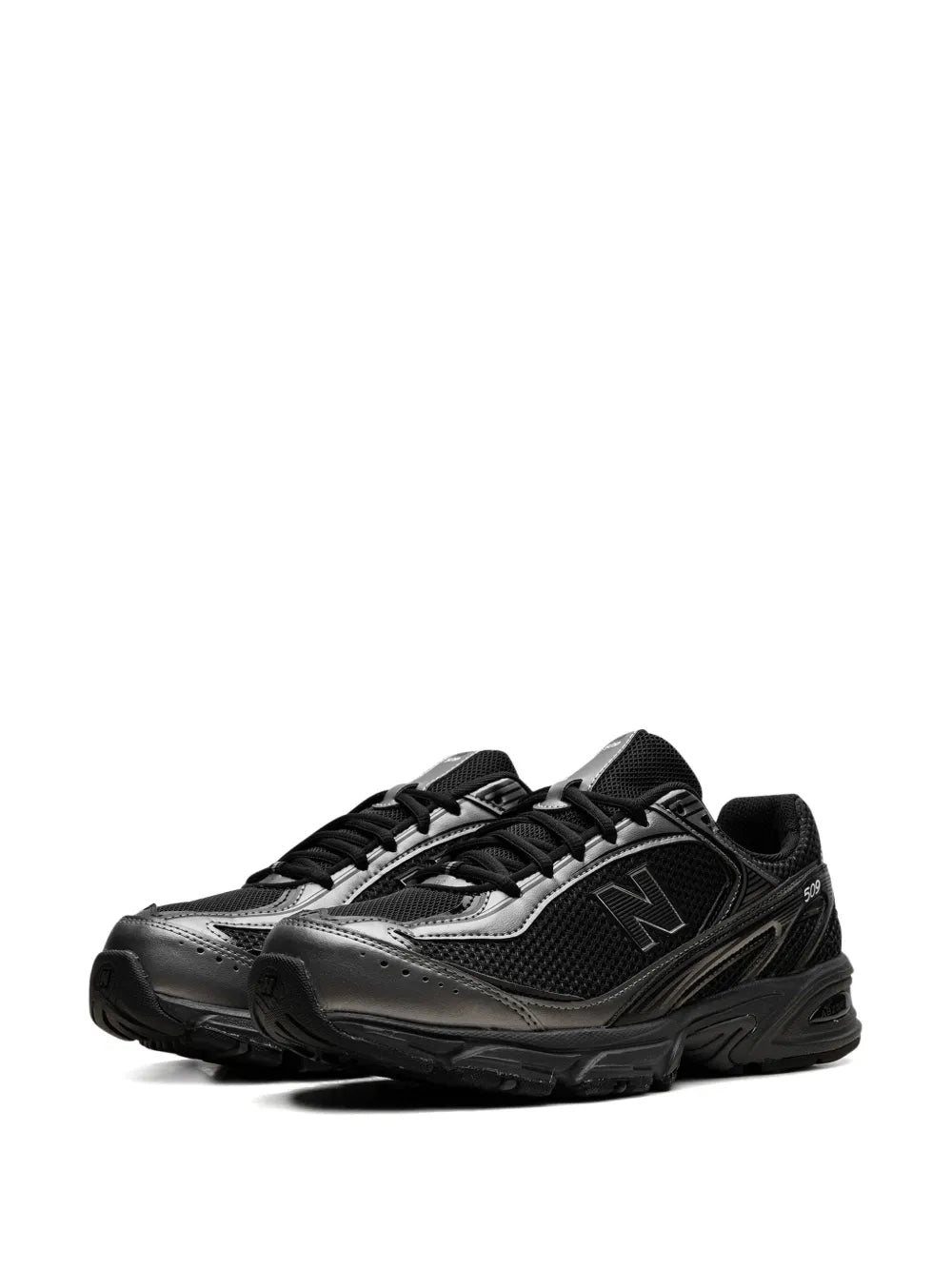 Black New Balance 509 sneakers with reflective silver panel and lace-up closure